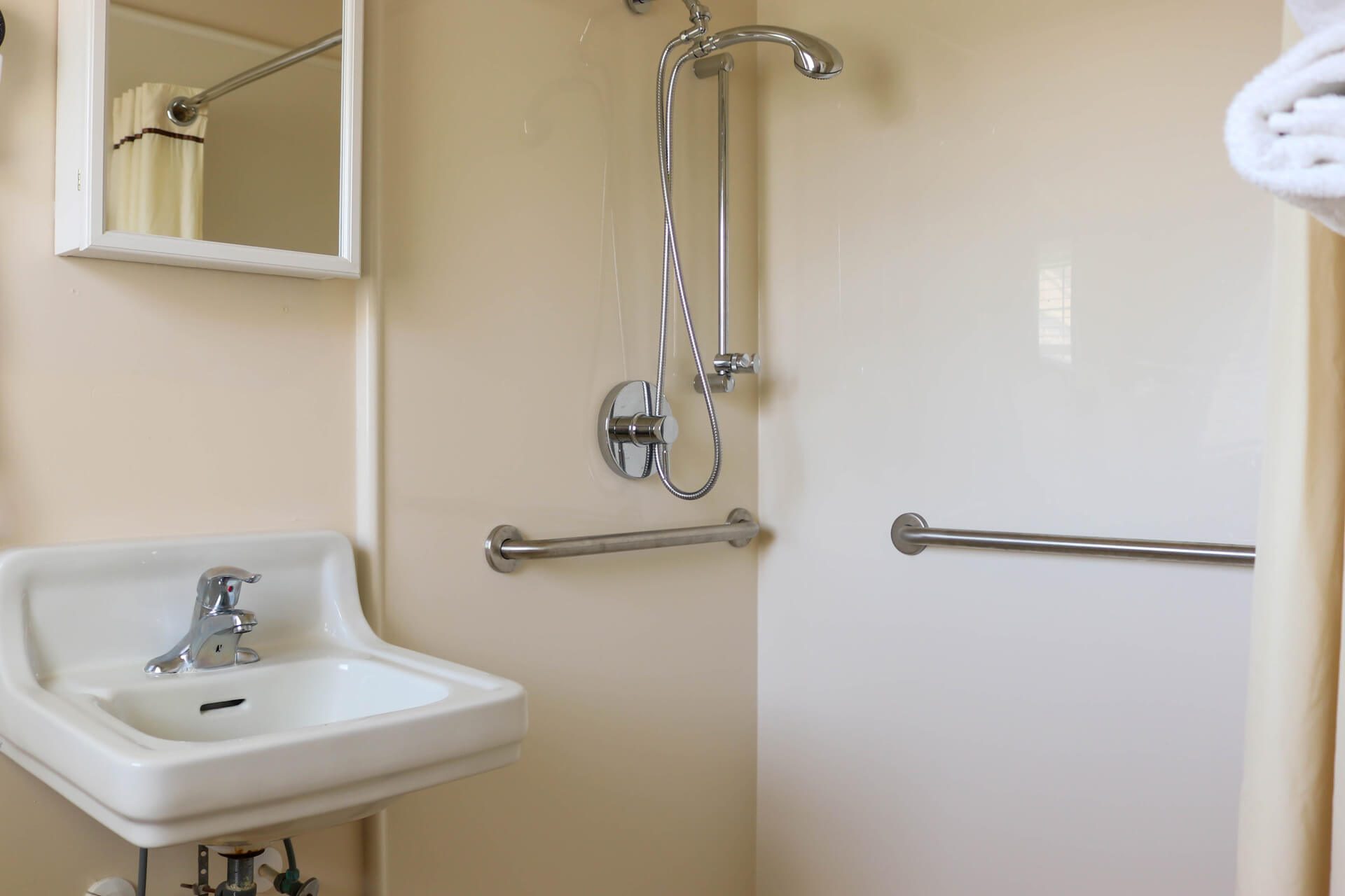 Ranch Style bathroom with shower grab bars and sink